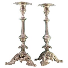 Silver candlesticks with turned stems and acanthus-cut bases