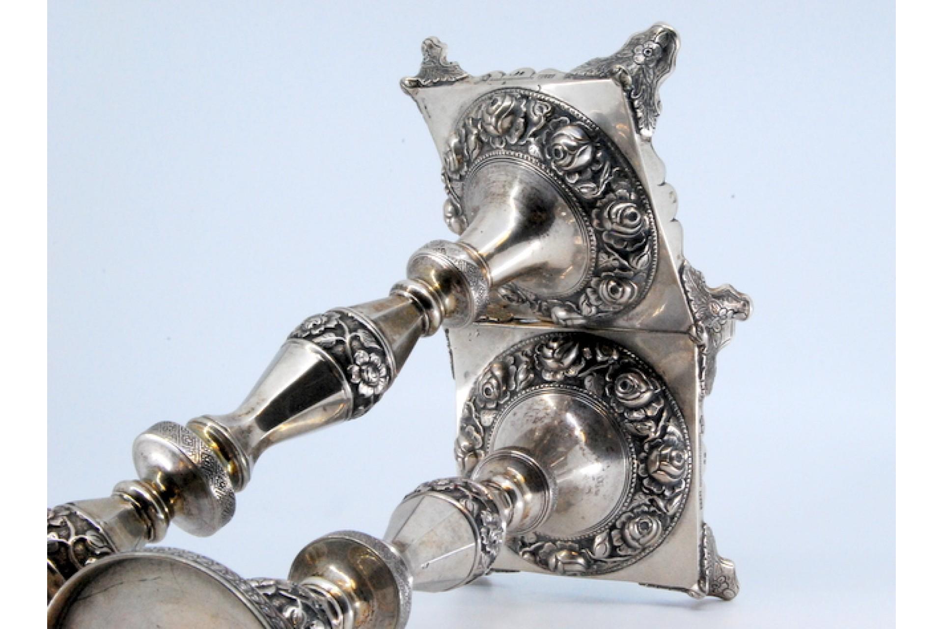 European Silver candlesticks with turned stems and floral reliefs on four-foot bases For Sale