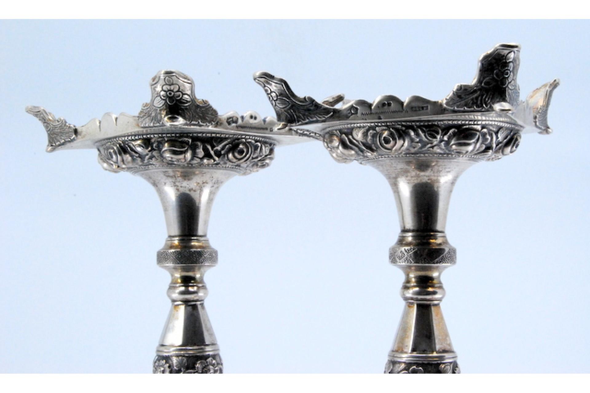 18th Century Silver candlesticks with turned stems and floral reliefs on four-foot bases For Sale