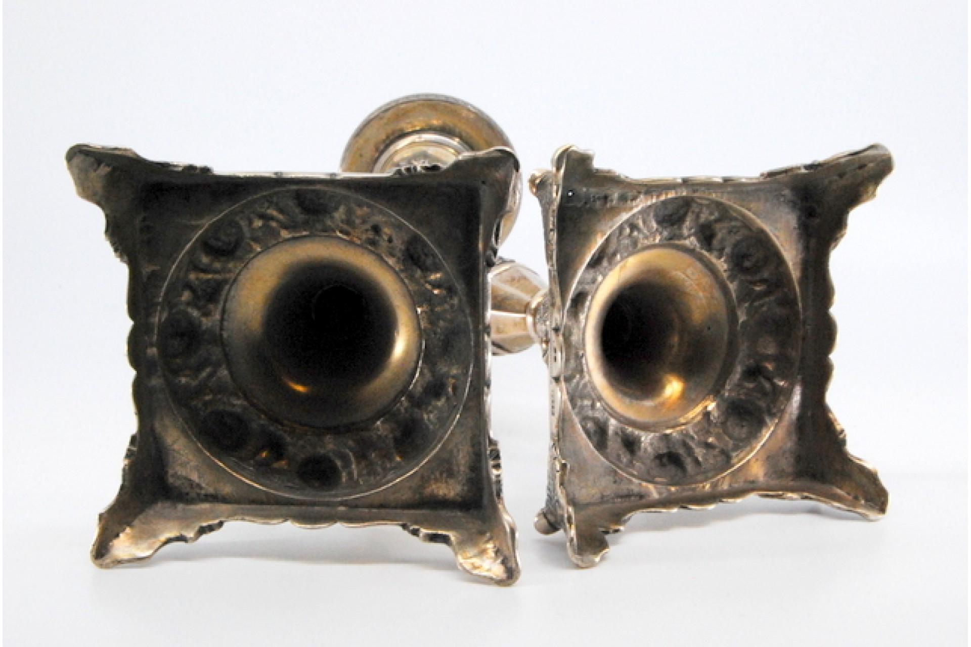 Silver candlesticks with turned stems and floral reliefs on four-foot bases For Sale 1