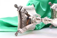 Silver candlesticks with turned stems on square bases with claw feet