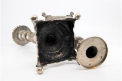 Silver candlesticks with turned stems on square bases with claw feet