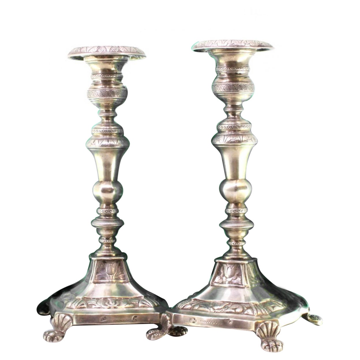 Silver candlesticks with turned stems on square bases with claw feet