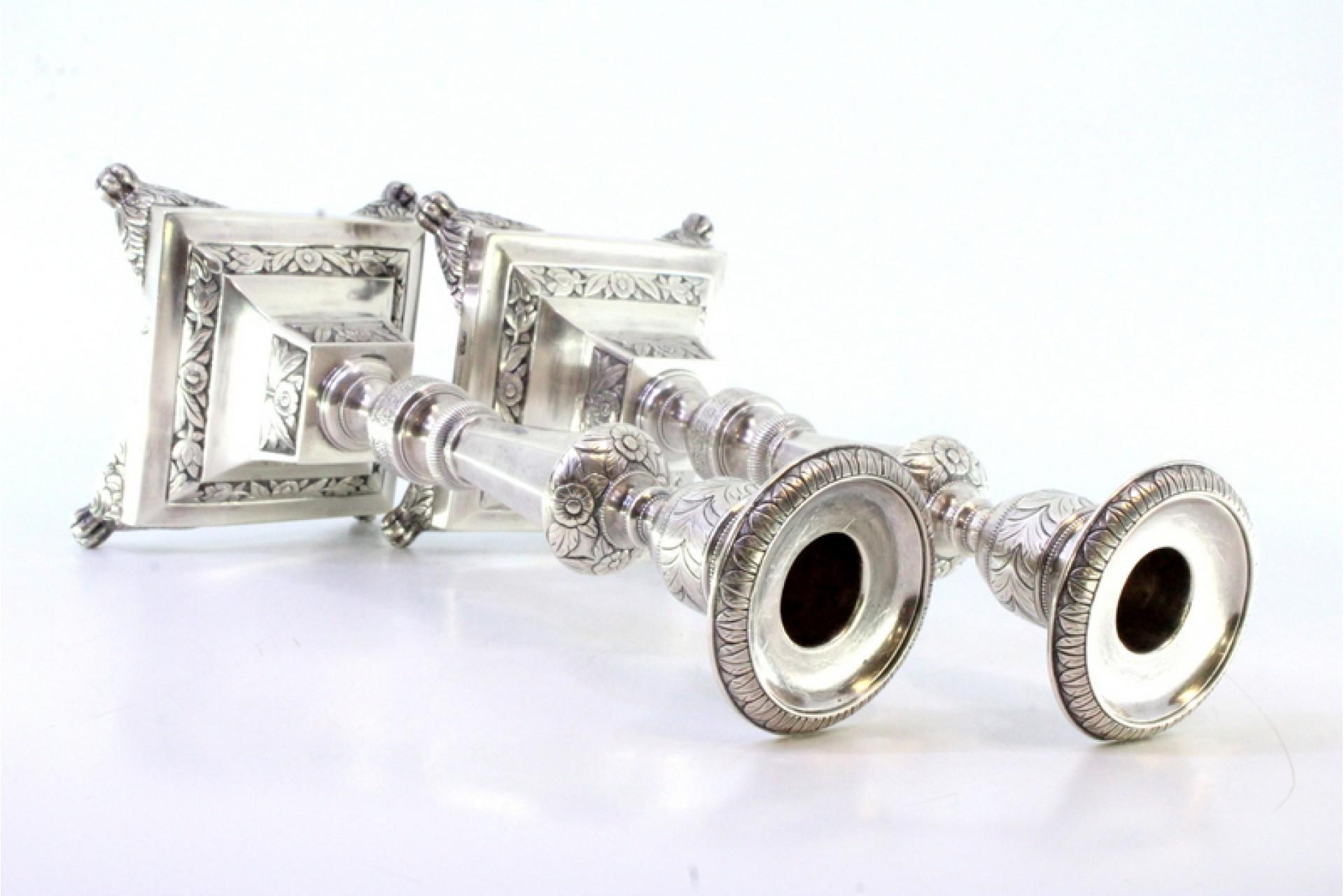 Description: Silver candlesticks with turned shafts, sconces and chiseled bases with four claw-shaped feet. Metal: Silver. Origin: Portuguese. Brand: Porto Coroa. Weight: 718.74 grams (Candlestick set). Dimensions: 9.8cm x 23cm. Content: 833/1000.