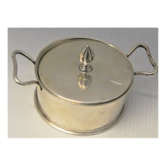 Silver candy box in the shape of a pot with a knob on the lid and a pearly bowl