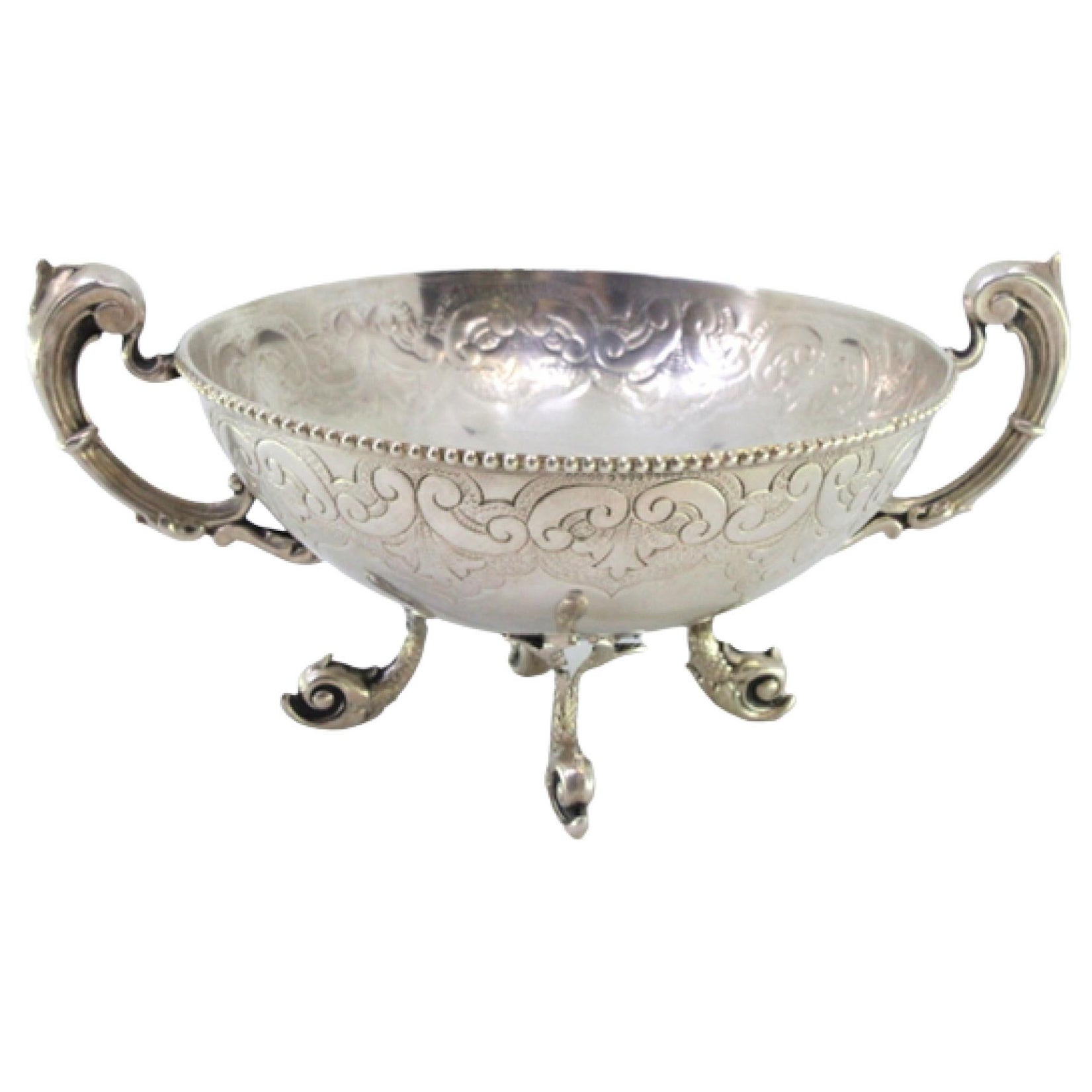 Silver candy box w/ engravings, cut-out handles
resting on 4 fish-shaped feet