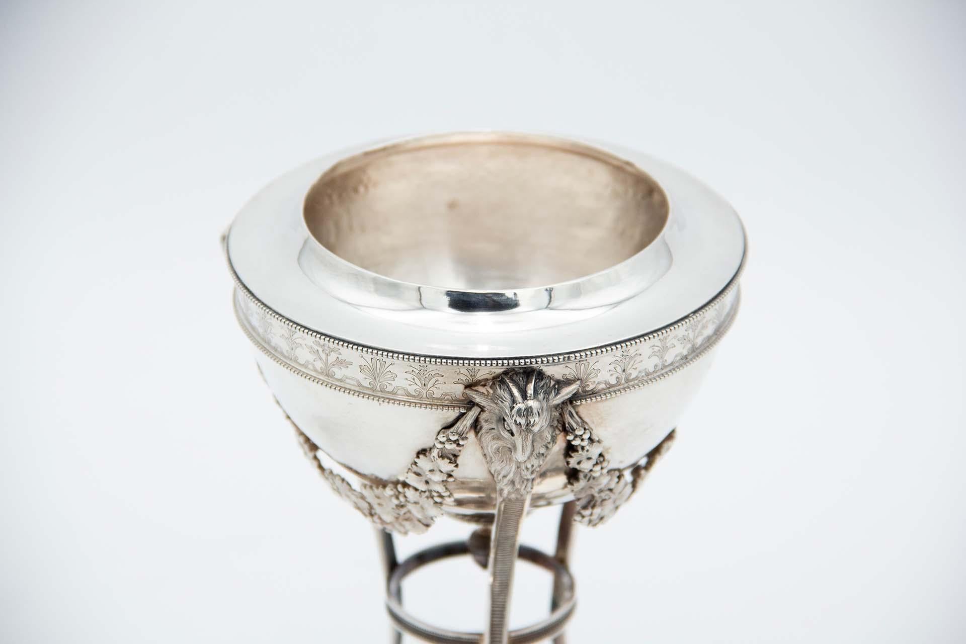 Description: Silver bonbon jar with pearly friezes, hanging garlands, animal heads, bird-shaped handle on the lid and resting on curved columns and three spherical feet. Metal: Silver. Origin: French. Mark: Old man's head frontal. Weight: 646.51