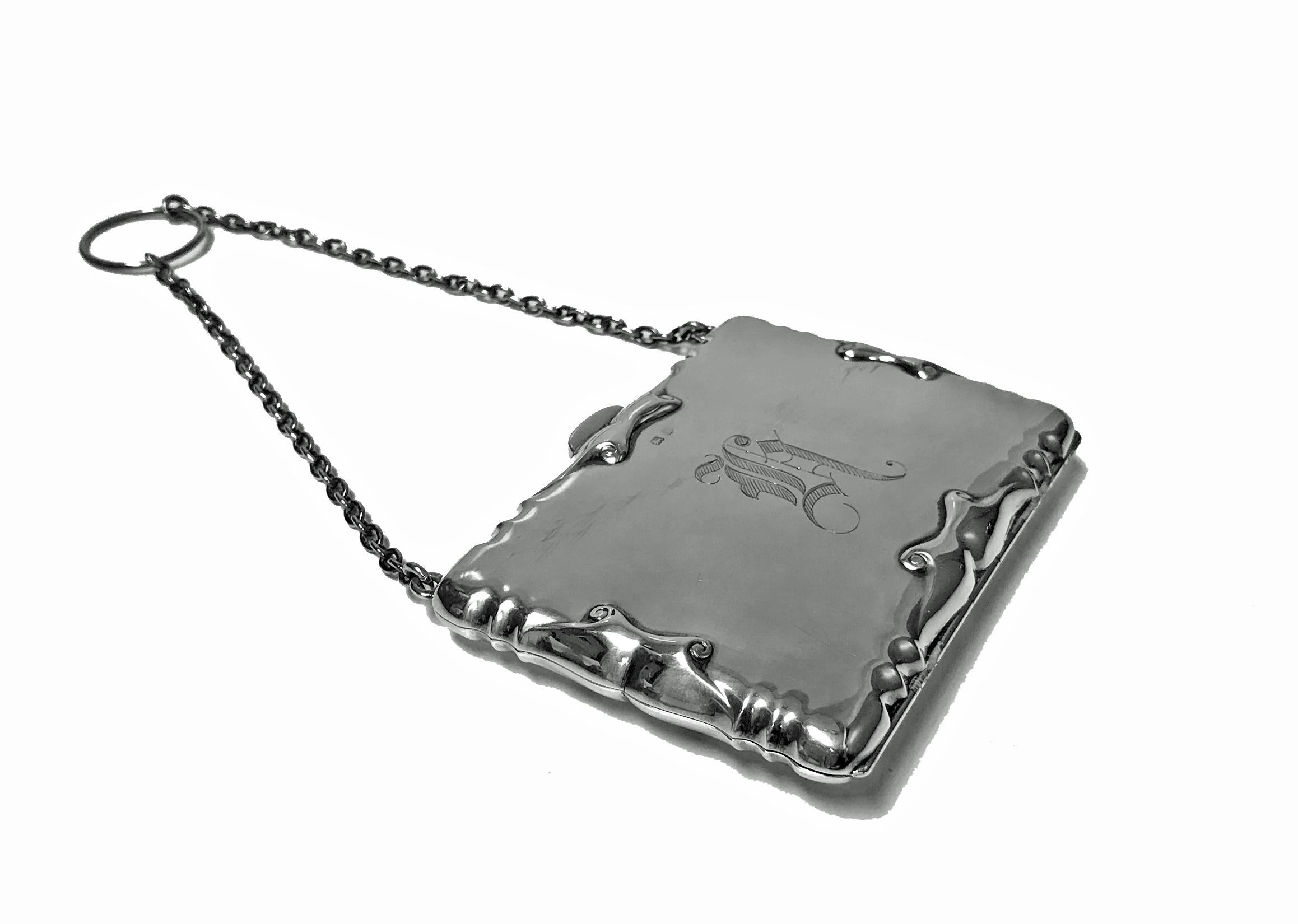Antique Silver Card Case in form of Aide Memoire Purse, Birmingham 1908, William Hair Haseler. Art Nouveau elaborate border surround, monogram possibly H. The interior with green lining and dividers and pencil. Measures: 3.75 x 2.75 inches