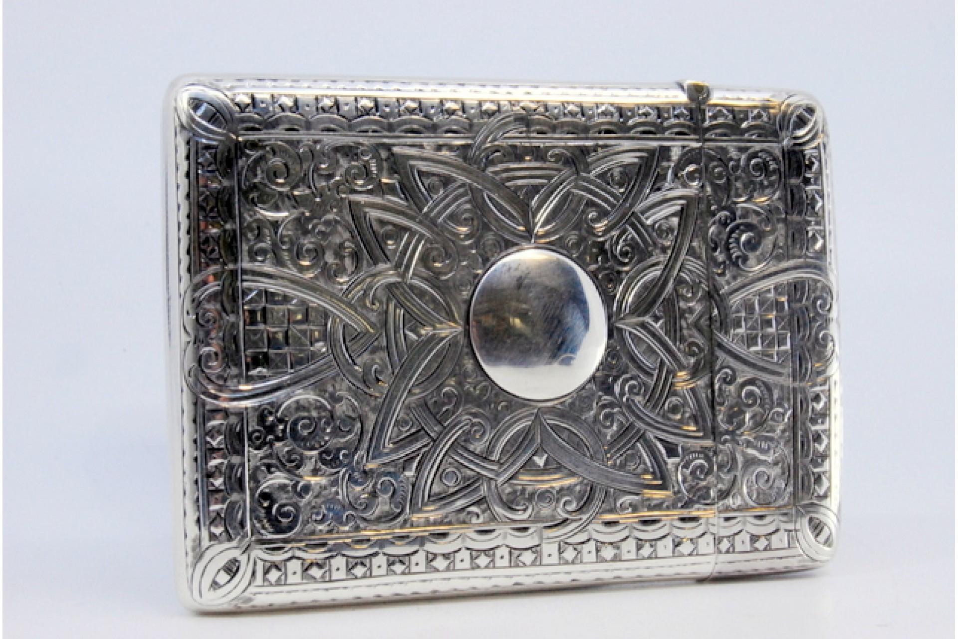 Description: Silver cardboard box with asymmetrical engraving of scrolls, garlands and hinged lid. Metal: Silver. Origin: English. Brand: Birmingham. Weight: 64.53 grams. Dimensions: 9.1x6.5cm. Content: 925/1000. Assay Mark: Yes, 1887 by J Walker.