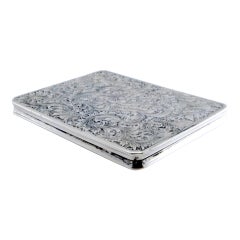 Silver cardboard box with engraved designs, hinged lid and gold interior