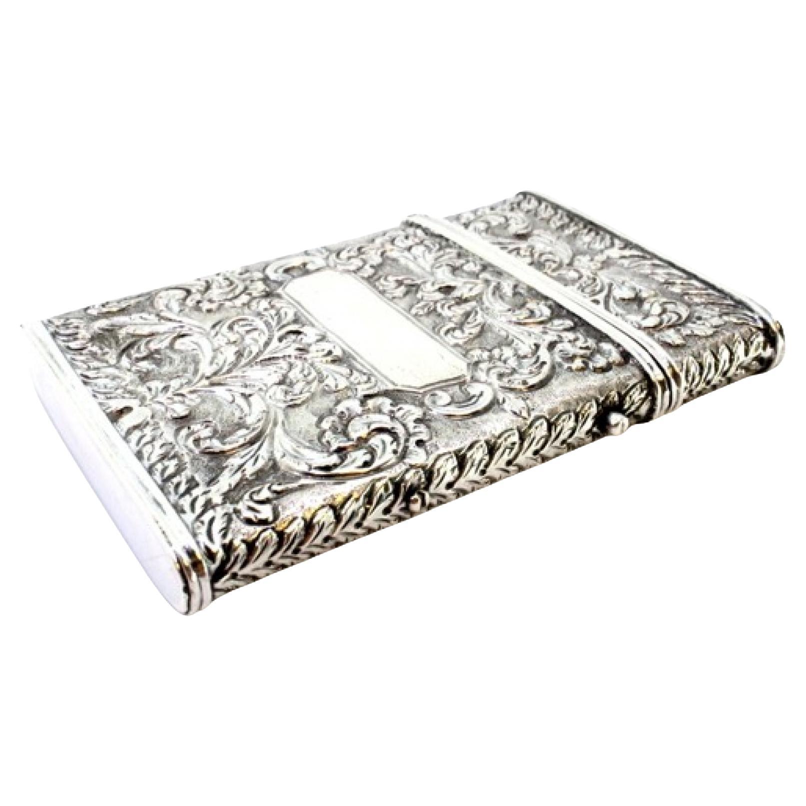 Silver cardboard box with revealed floral motifs, monogram cards and hinged lid