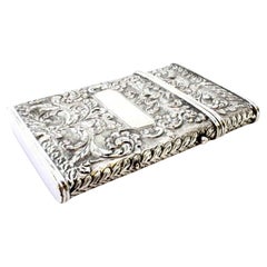 Silver cardboard box with revealed floral motifs, monogram cards and hinged lid