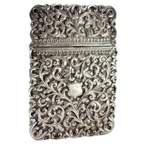 Silver carton box with reliefs and monogram with hinged lid