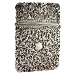 Silver carton box with reliefs and monogram with hinged lid