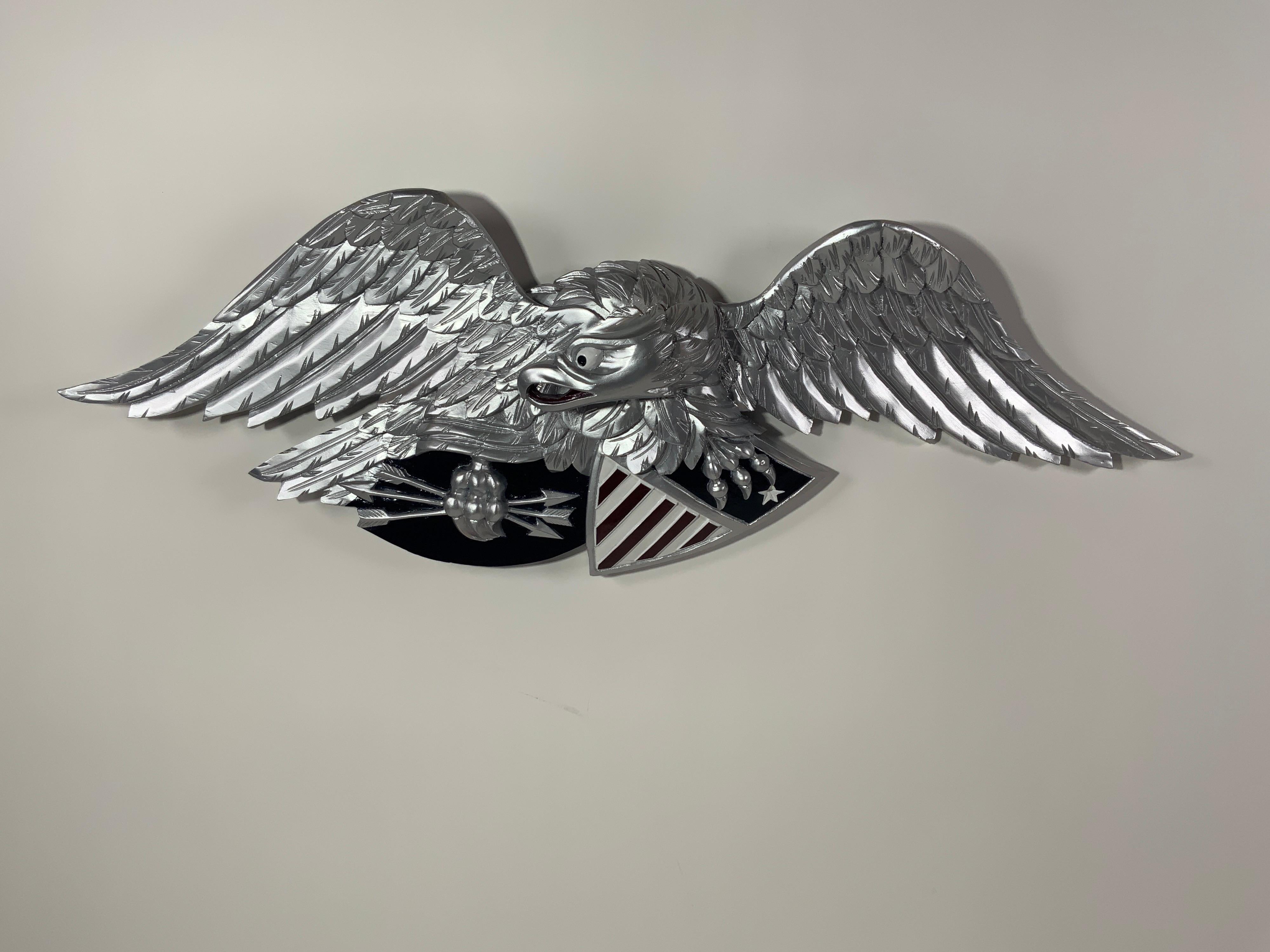 Finely carved American eagle with bright silver finish. Eagle is shown clutching arrows and a patriotic shield. Shield is painted red, white and blue.

Overall dimensions: 13