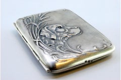 Silver case with Art Nouveau dog relief among reeds and hinged lid