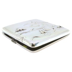 Silver case with Art Nouveau floral reliefs, holders inside and hinged lid