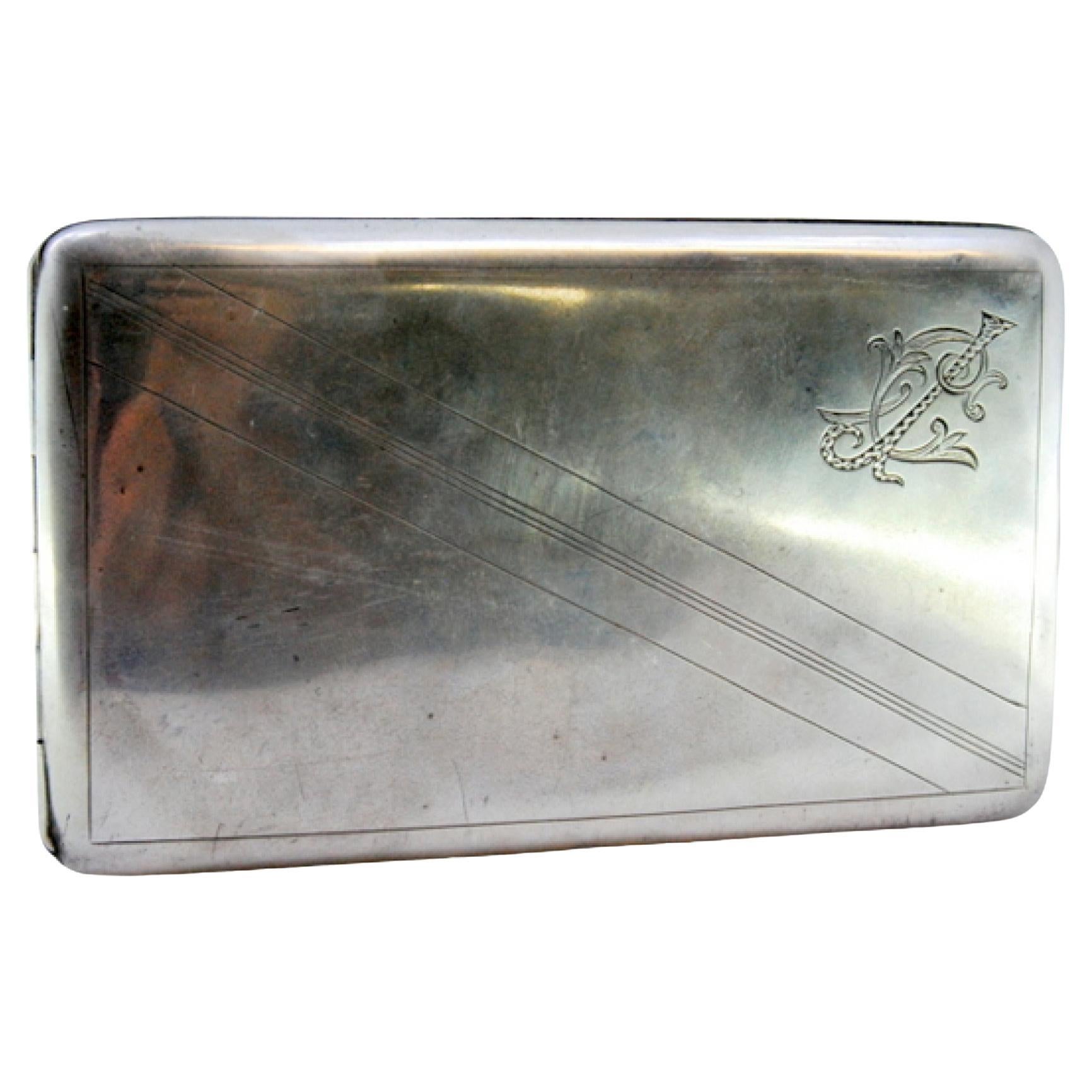 Silver case with diagonal band engravings, gold interior and hinged lid