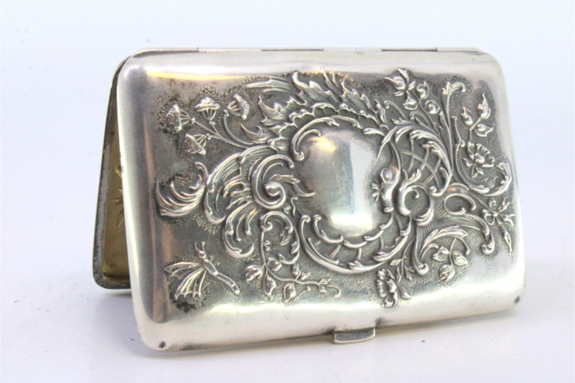 Silver case with embossed florals around monogram and hinged lid For Sale 1