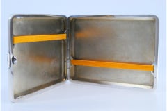 Silver case with engravings around monogram, holder inside and hinged lid