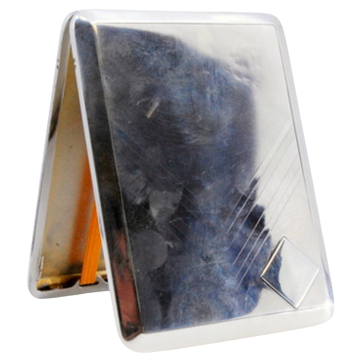 Silver case with engravings around monogram, holder inside and hinged lid