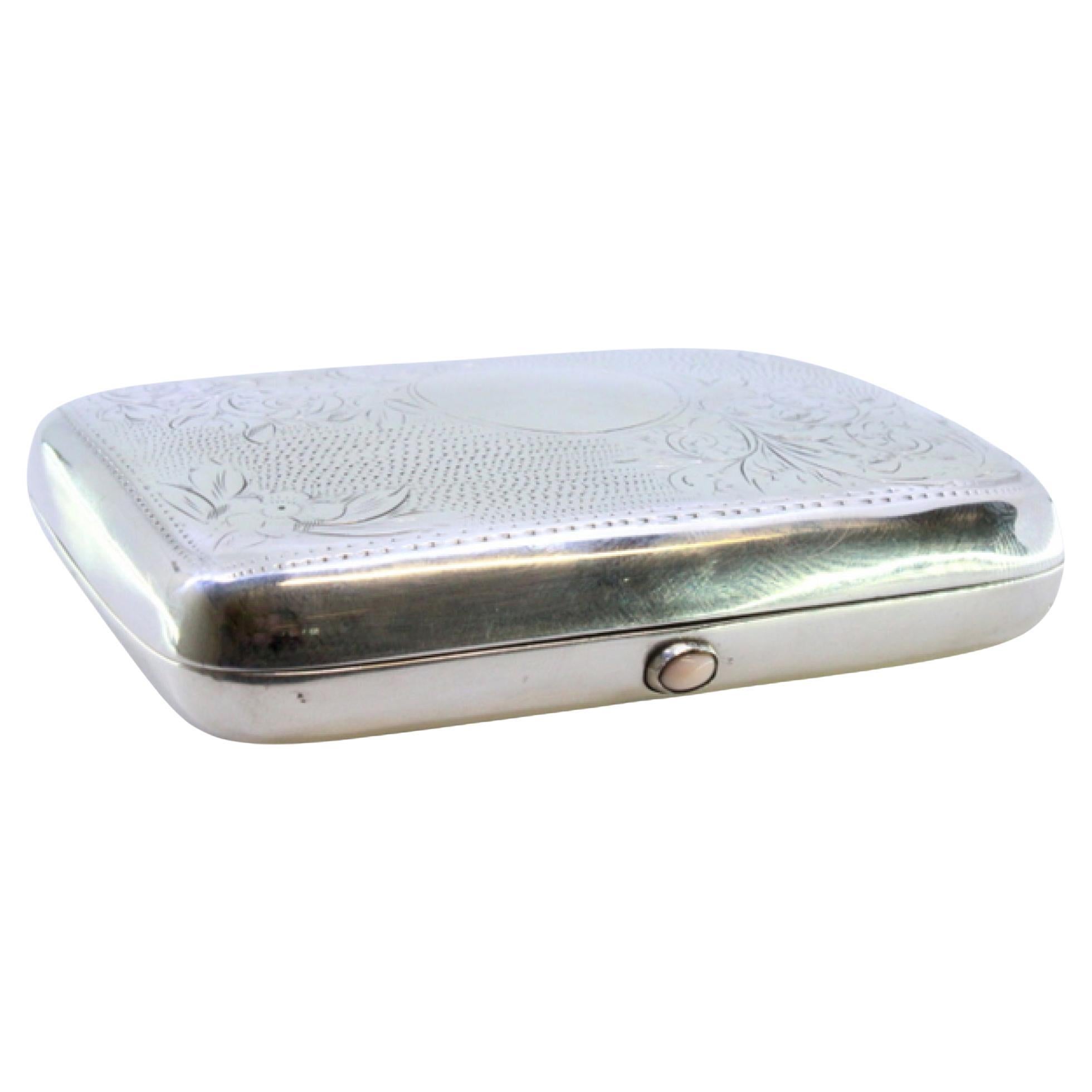Silver case with floral engravings, curved monogram and spring-hinged lids