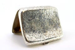 Estuche de plata con grabados florales, tarjeta monograma y tapa abatible