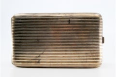 Silver case with fluted lengthwise bands, gold interior and hinged lid