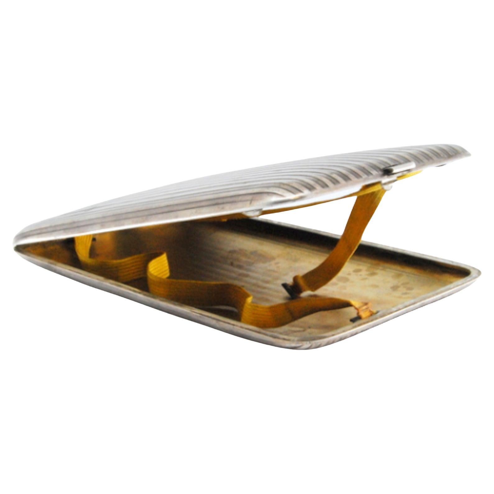 Silver case with fluted lengthwise bands, gold interior and hinged lid