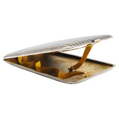 Silver case with fluted lengthwise bands, gold interior and hinged lid