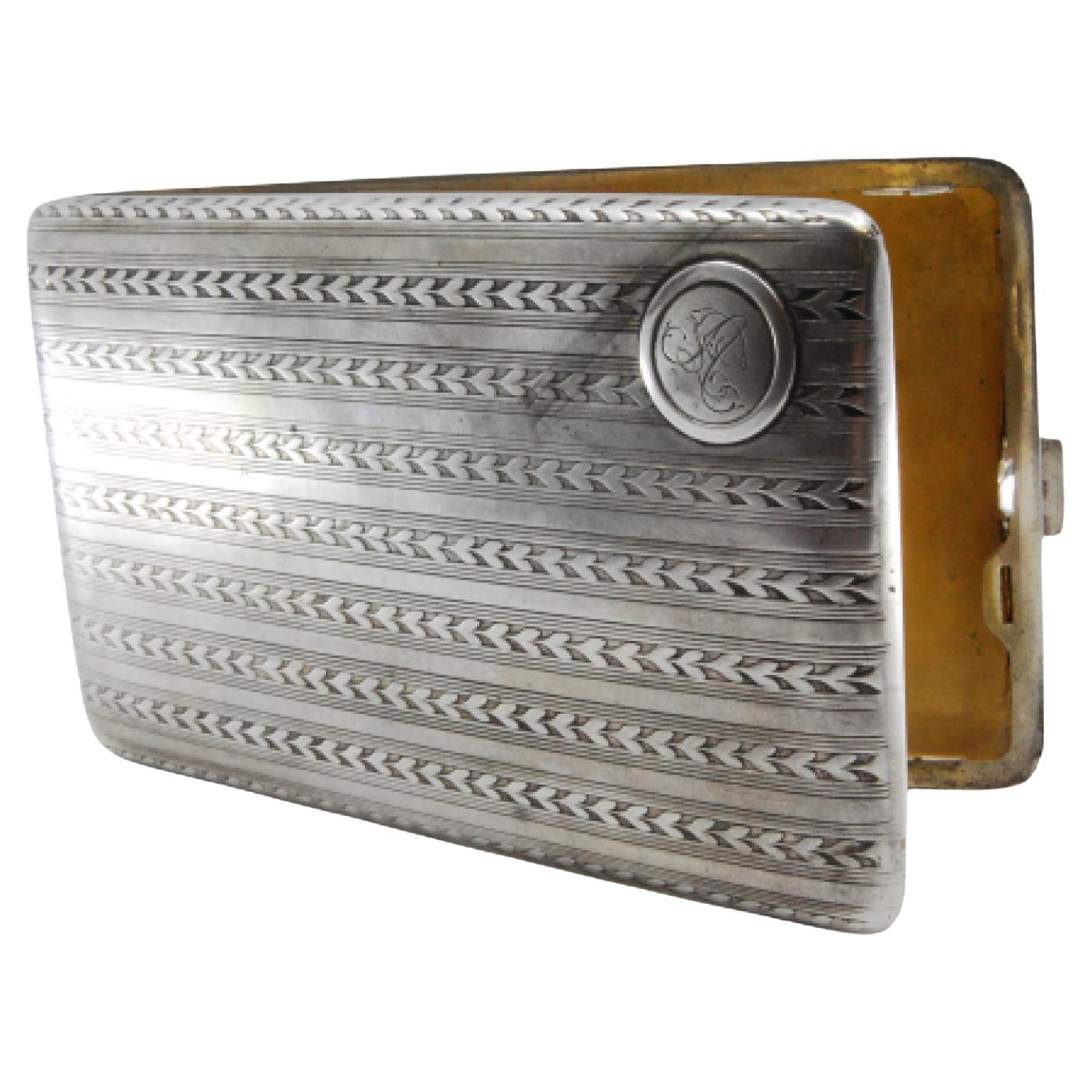 Silver case with herringbone bands, monogram, gold interior and hinged lid