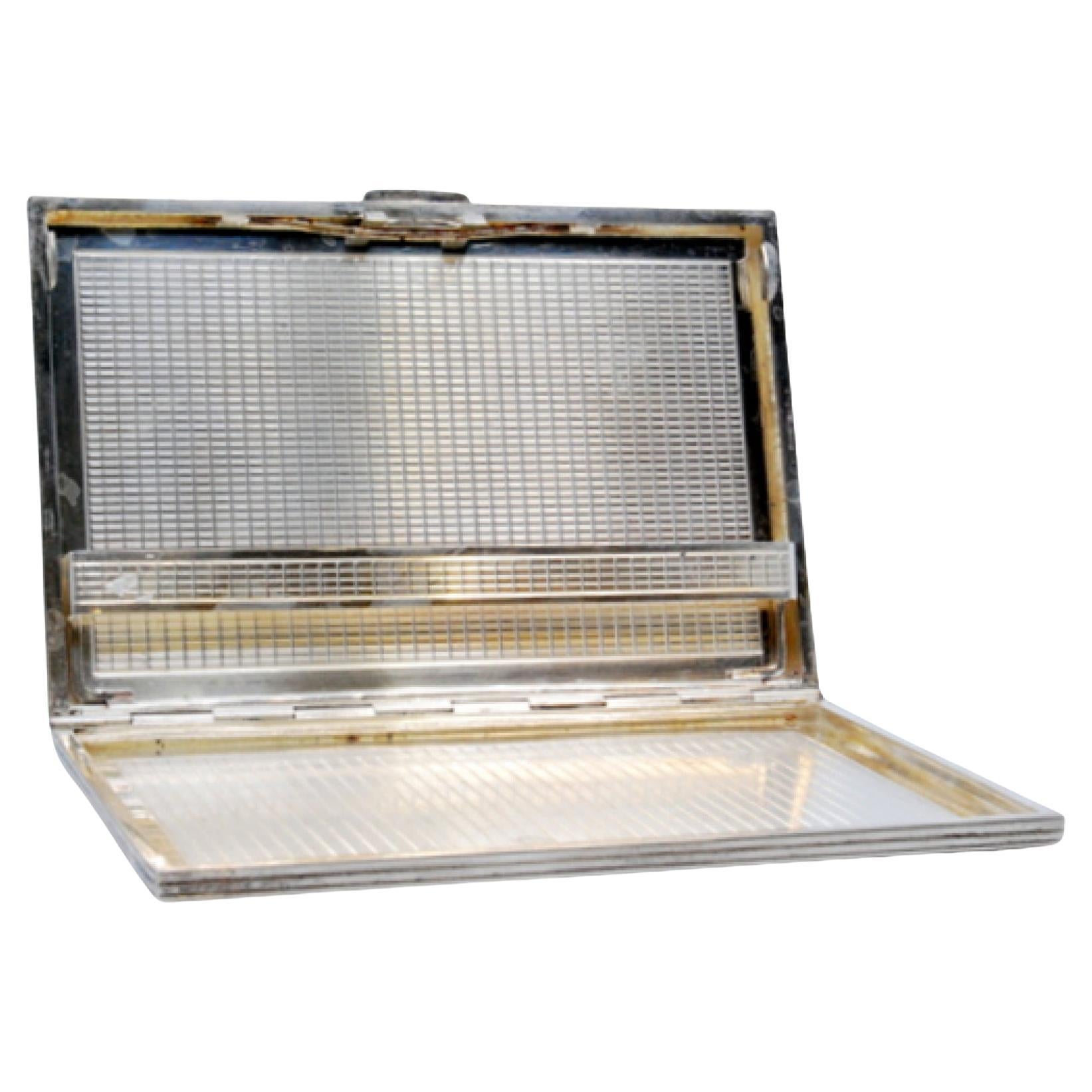 Silver case with herringbone engravings and spring interior support