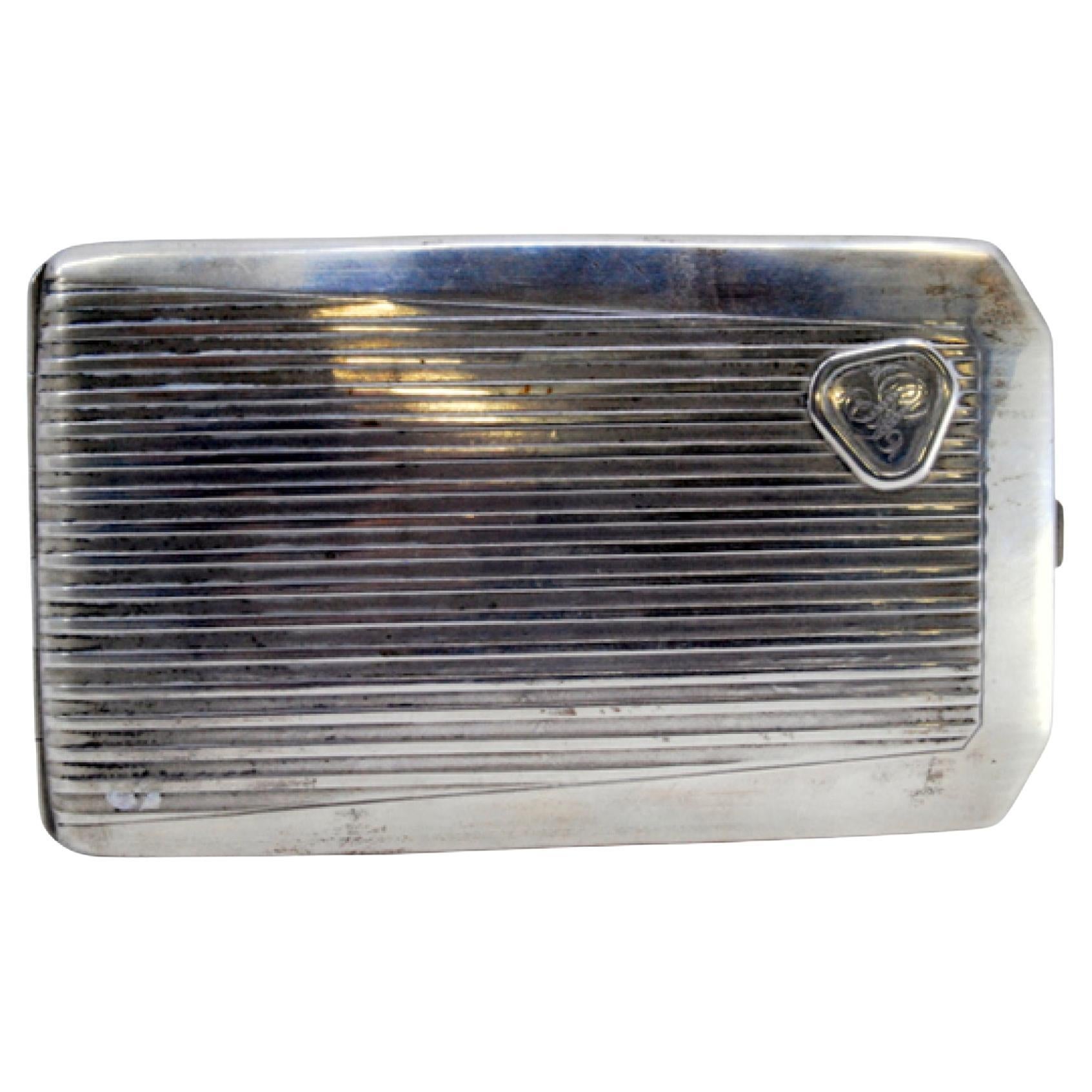 Silver case with lengthwise bands, monogram and gold interior