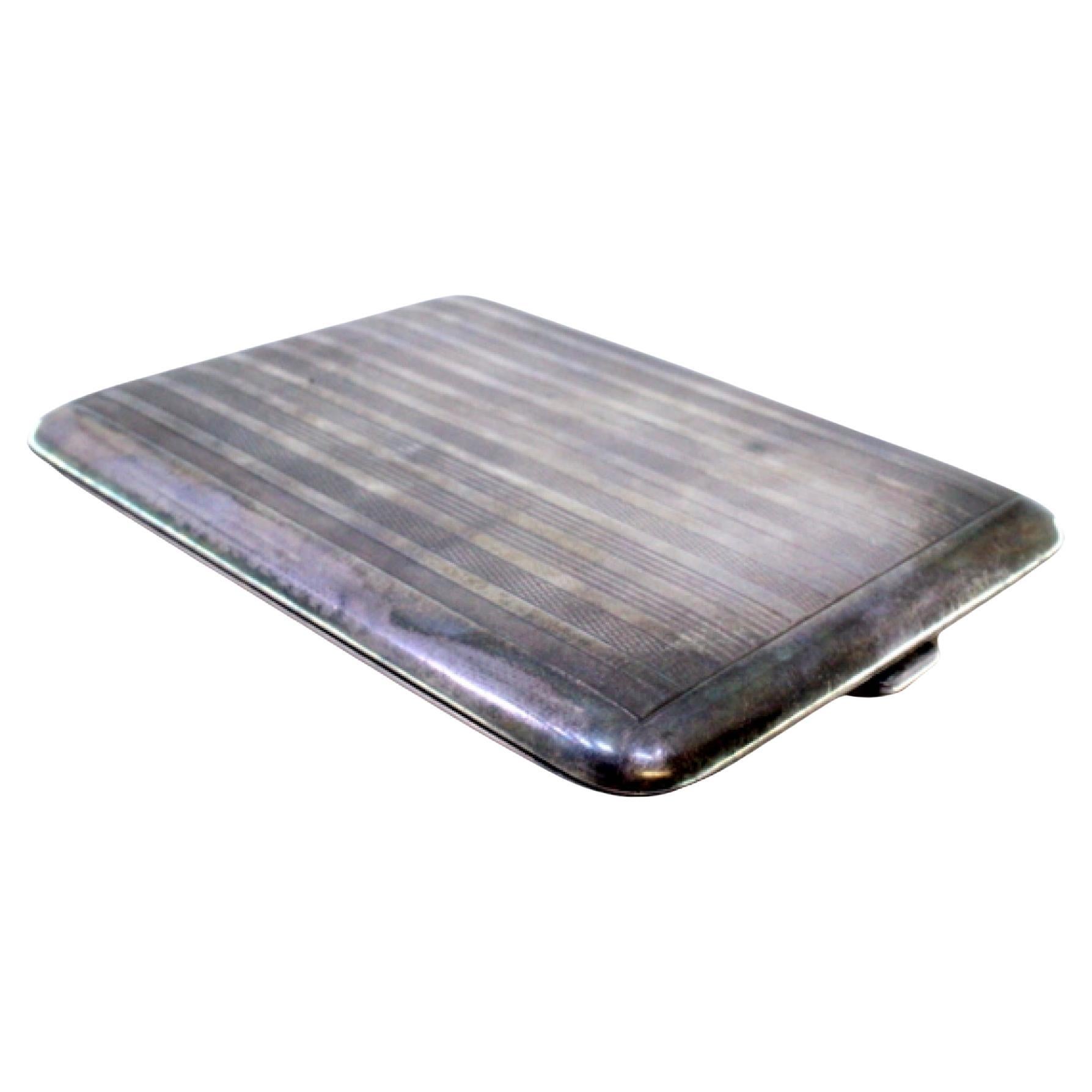 Silver case with lengthwise guilloche bands, hinged lid and gold interior