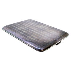 Silver case with lengthwise guilloche bands, hinged lid and gold interior