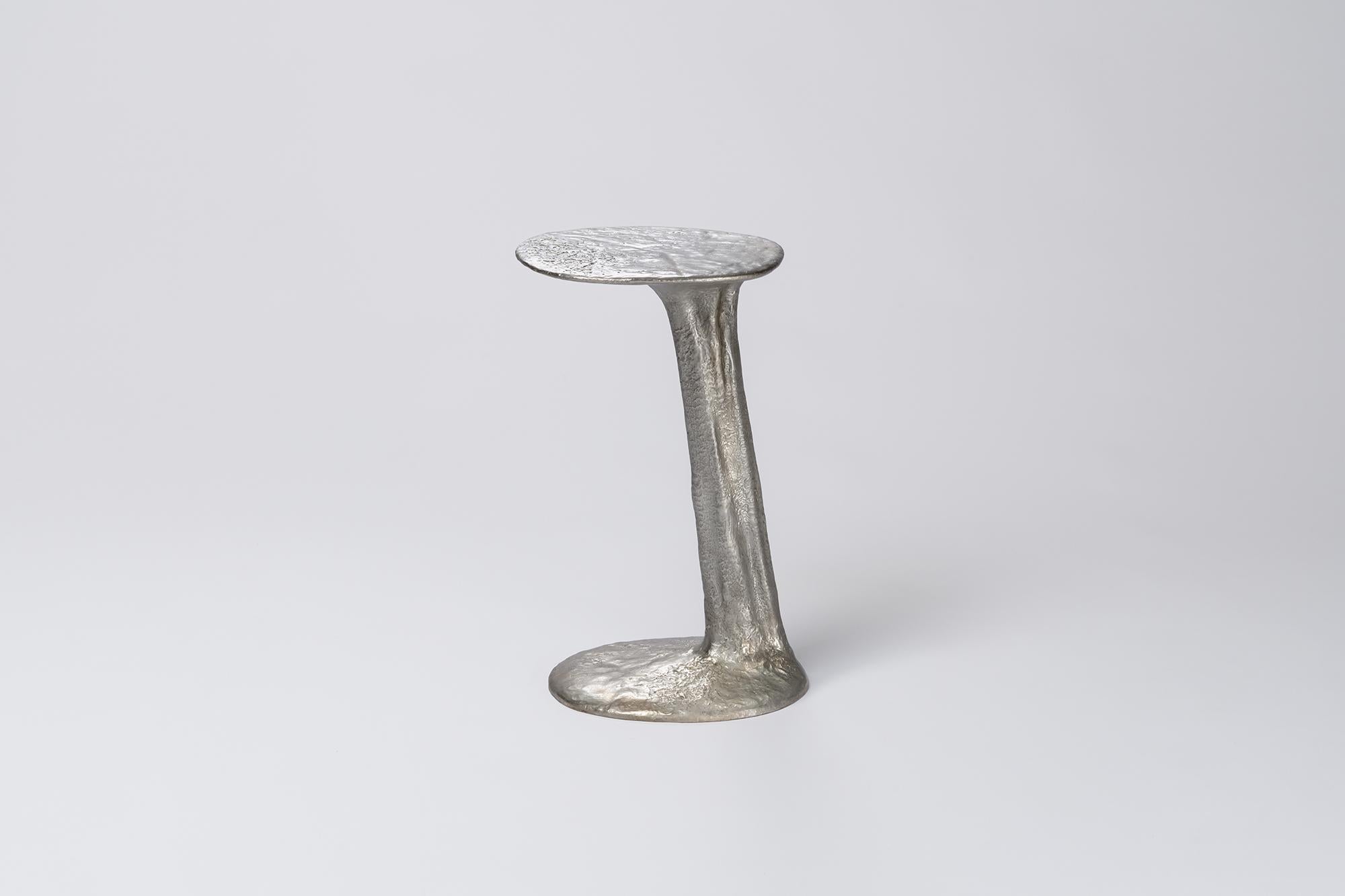 Silver Cast Brass Lava Small Side Table by Atelier V&F
Dimensions: D 35 x W 30 x H 53 cm. 
Materials: Cast brass with a silver finish.

Available in different finishes (cast, black and silver). Available in two different sizes. Prices may vary.