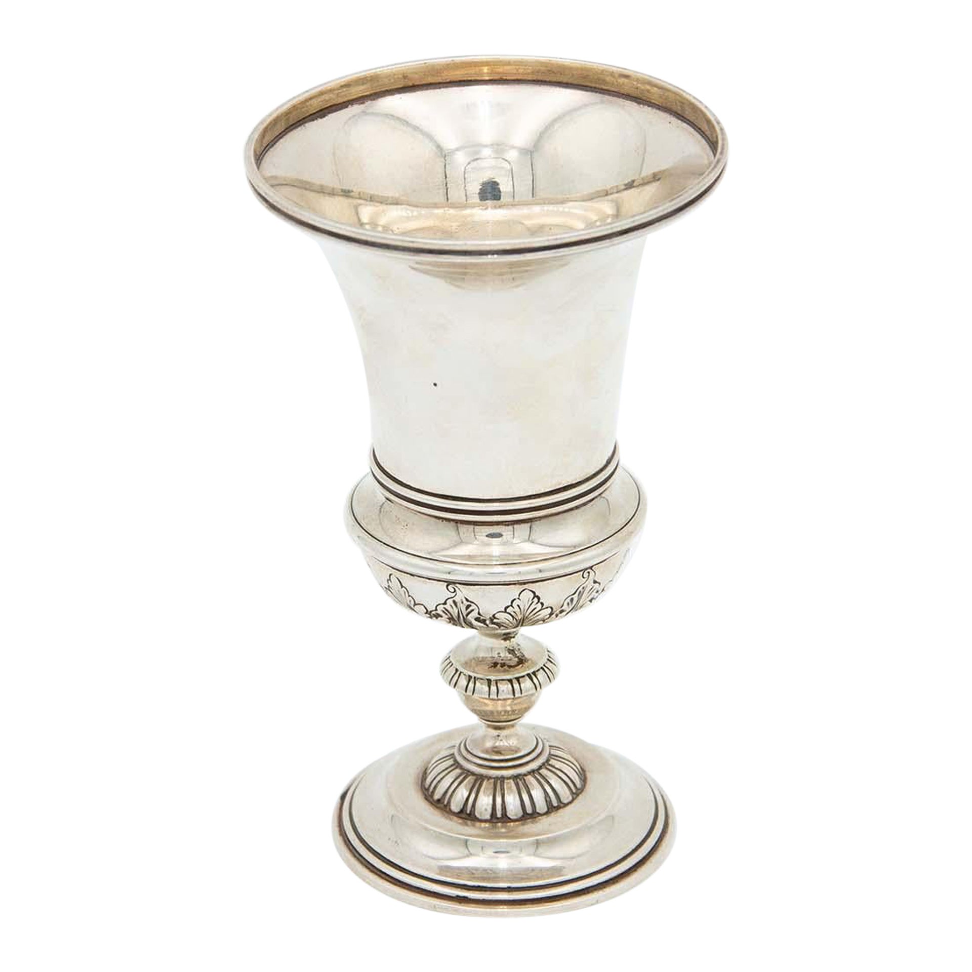 Silver chalice with a smooth body and relief on the base