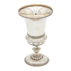 Silver chalice with a smooth body and relief on the base