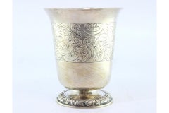 Silver chalice with engravings and raised base with floral motifs