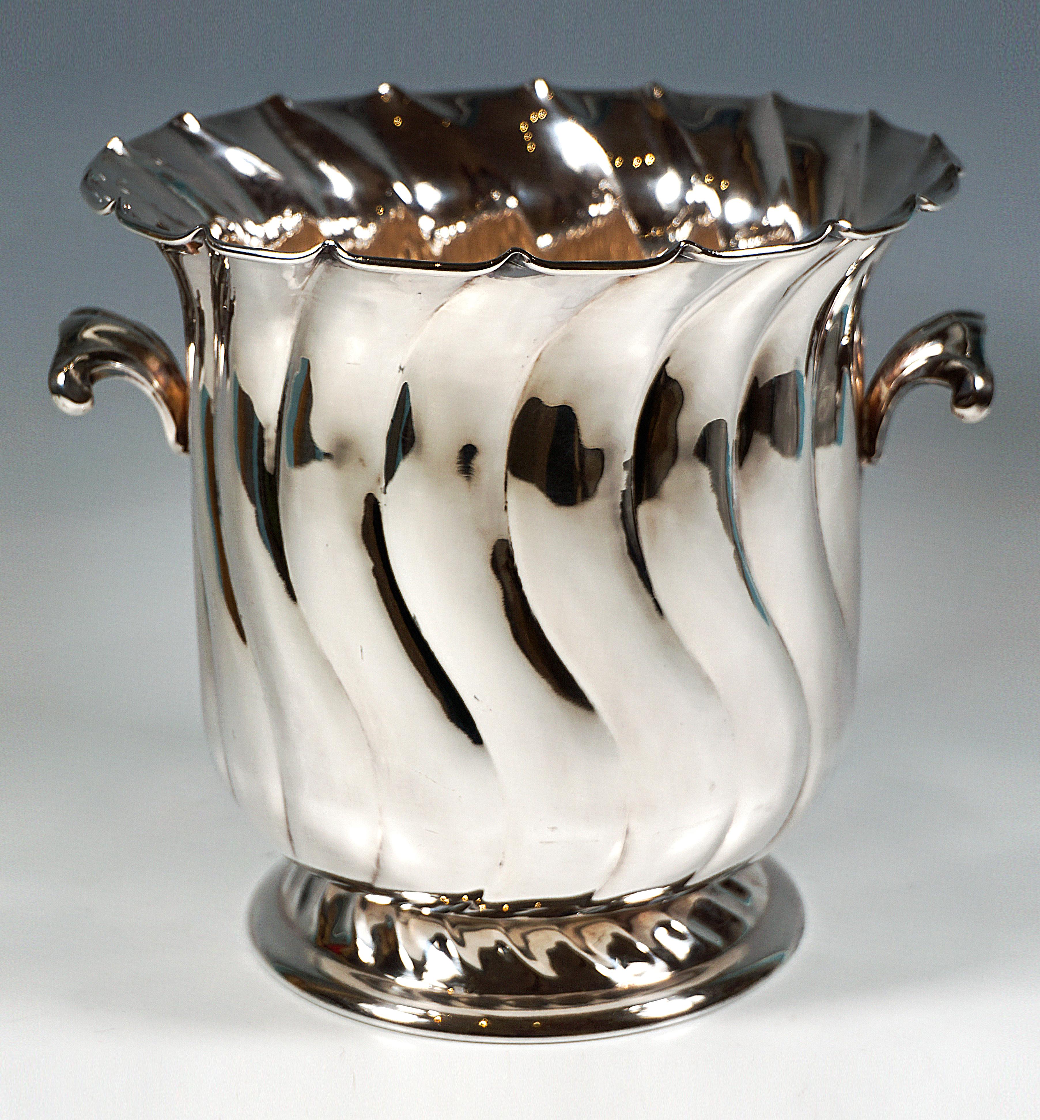 Elegant silver vessel in the shape of a tulip with a wide opening on a stepped stand, the wall and foot with curved folds, the upper rim profiled and turned outwards, two raised rocaille handles attached to the upper section.

Italian official