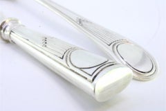 Silver cheese knife and fork set with exposed handles enclosing monogram cards