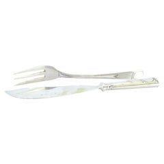 Silver cheese knife and fork set with exposed handles enclosing monogram cards