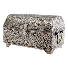Silver chest-shaped jewelry box with chiseled plant motifs and lined interior