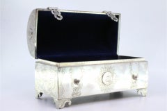 Silver chest-shaped jewelry box with coin appliqués, blue velvet & cut-out feet