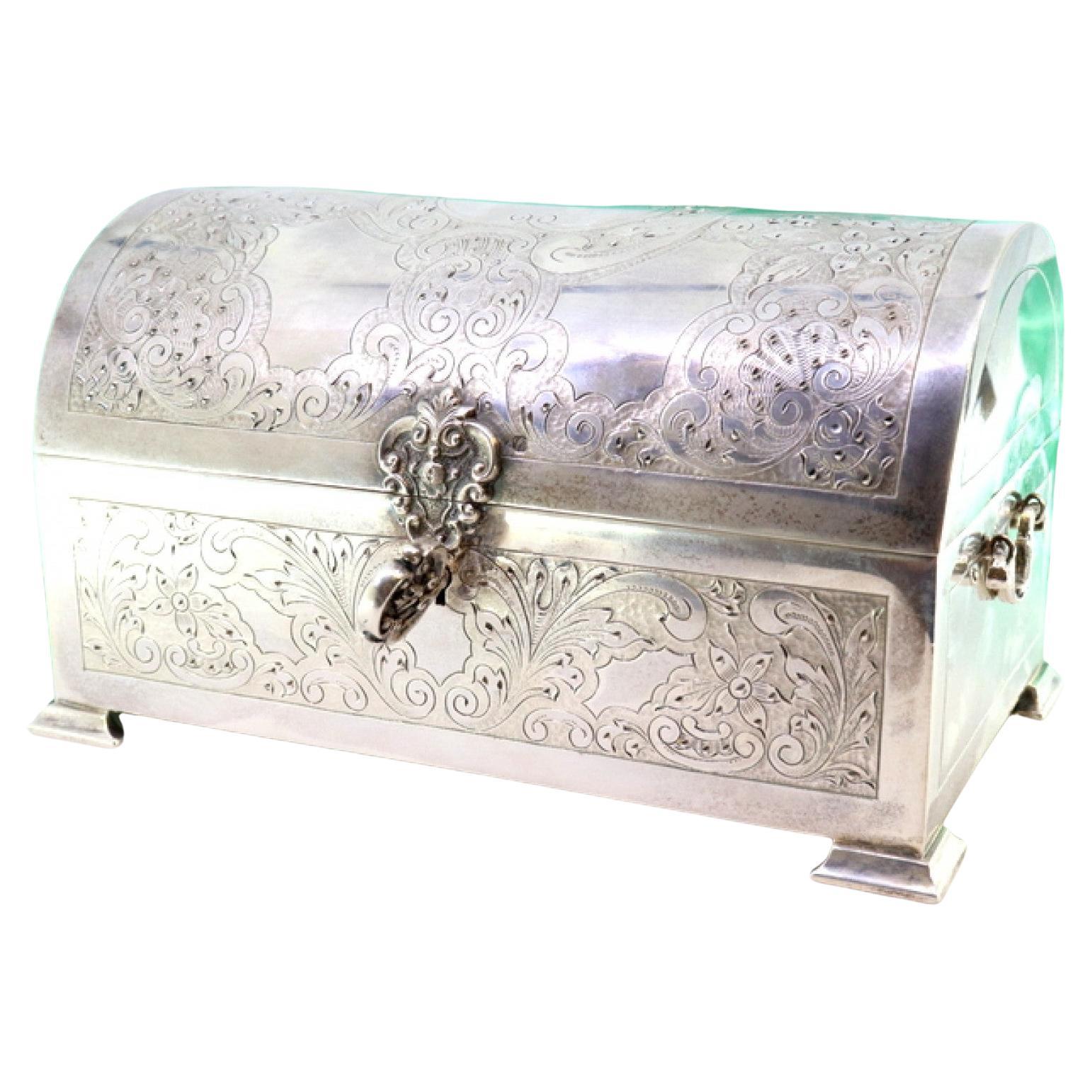 Silver chest-shaped jewelry box with reliefs, guilloche, and blue velvet lining