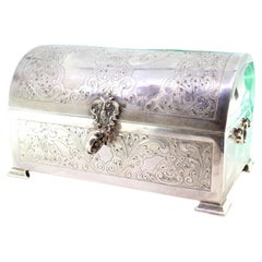 Silver chest-shaped jewelry box with reliefs, guilloche, and blue velvet lining