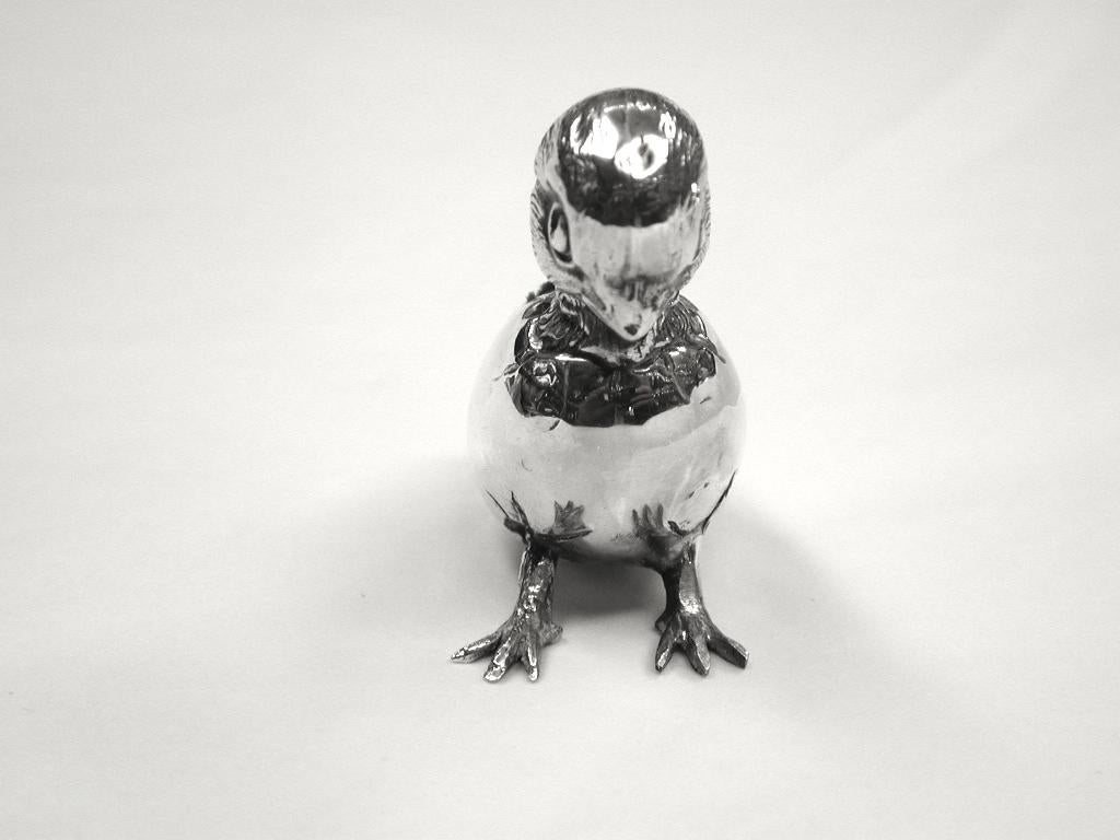 Silver chick pin cushion, dated 1910, Birmingham.
Novelty pin cushion of a newly hatched chick coming out of its shell.