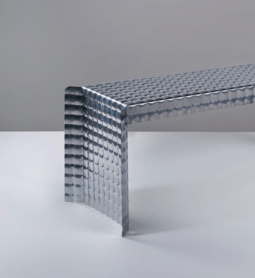 Silver/ Chrome Pressure bench by Tim Teven
Pressure Series (2018 - Ongoing)
Dimensions: 90 x 30 x 39 cm
Materials: Aluminium, Powder coating

In the pressure series, Tim Teven uses material deformation under extreme pressure as a tool to