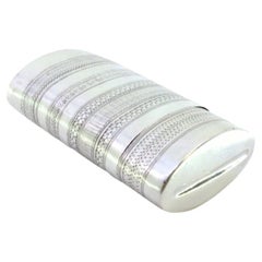 Silver cigar case with engraved wreaths and friezes around the lid