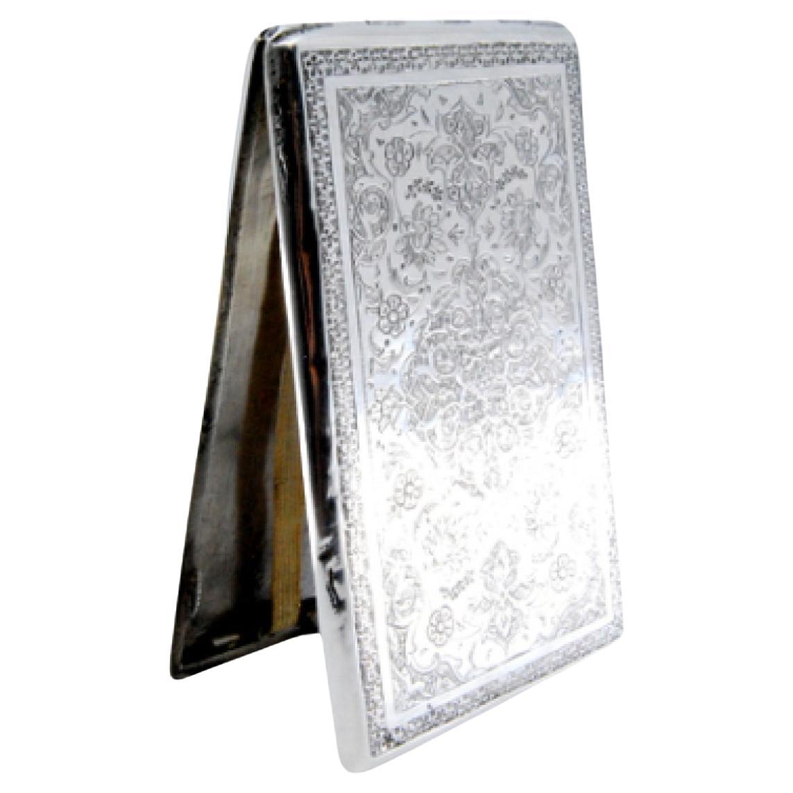 Silver cigarette case with Arabic-style engraved floral motifs and hinged lid
